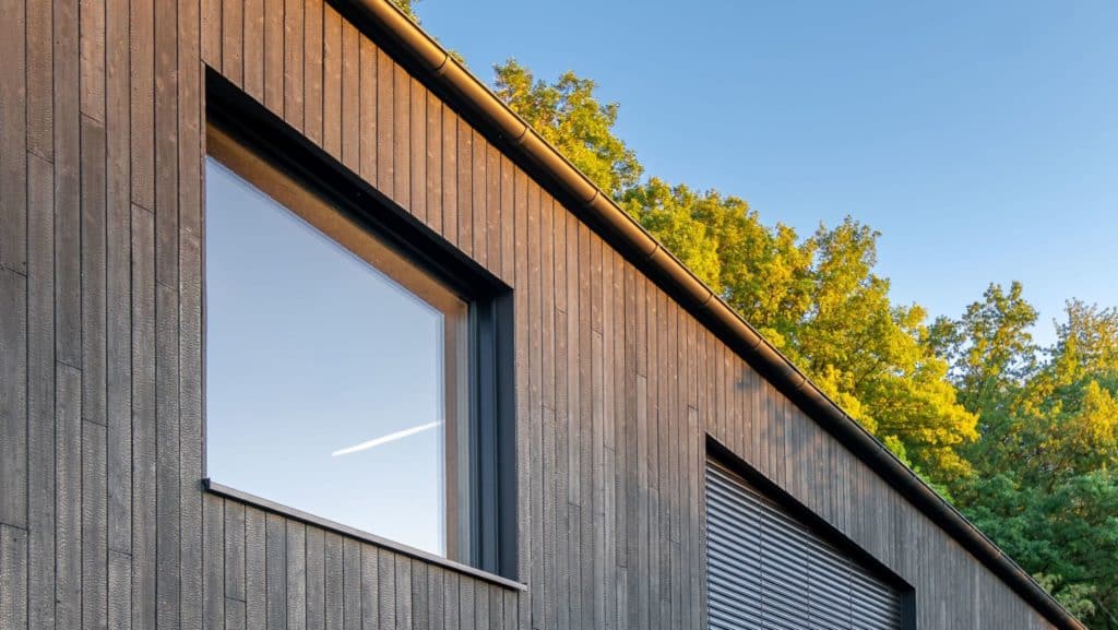 Black house with windows in the sun
